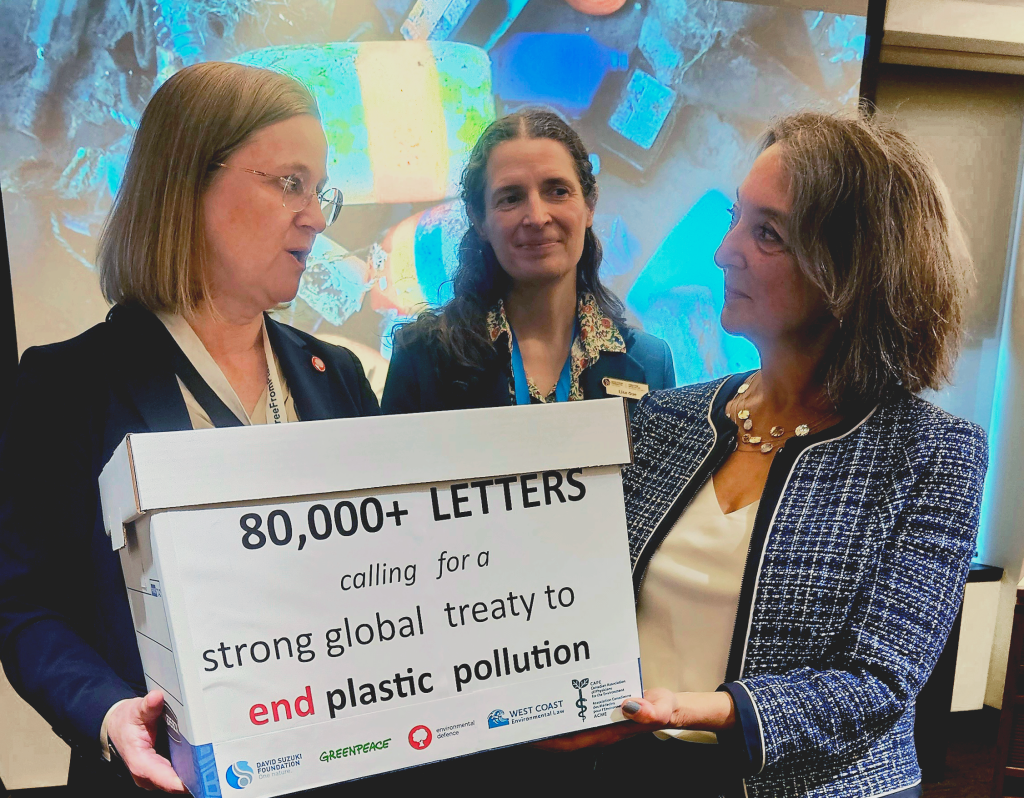 Karen Wirsig from Environmental Defence Canada and MP Julie Dabrusin holding a box labelled "80,000+ Letters" with Lisa Gue from David Suzuki Foundation standing behind