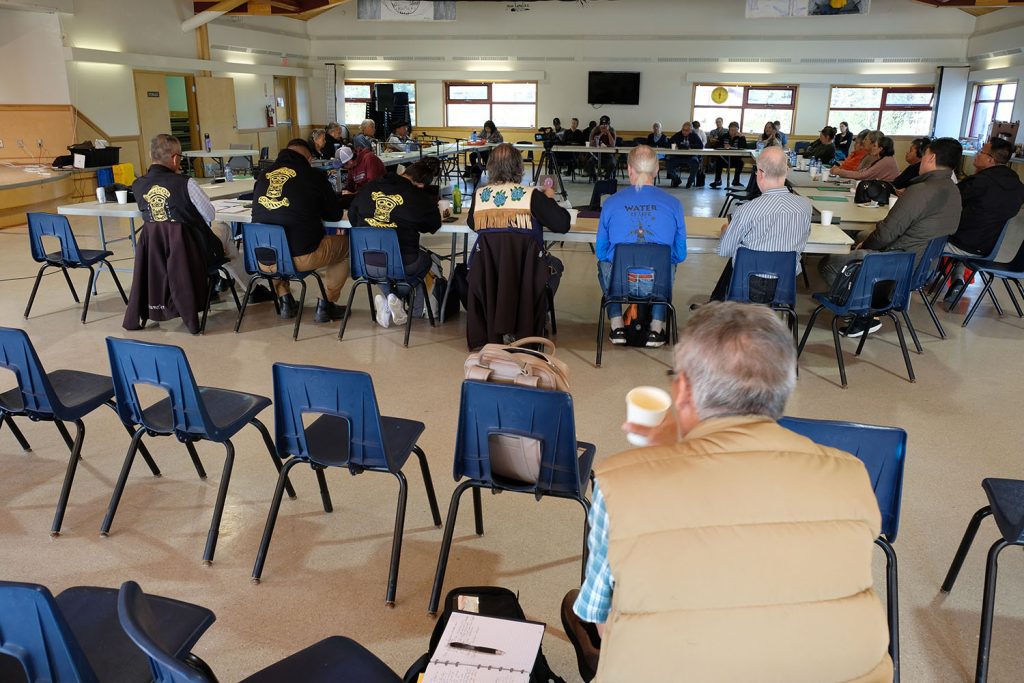 Participants of the sharing circle sit in a square-layout to listen to speakers