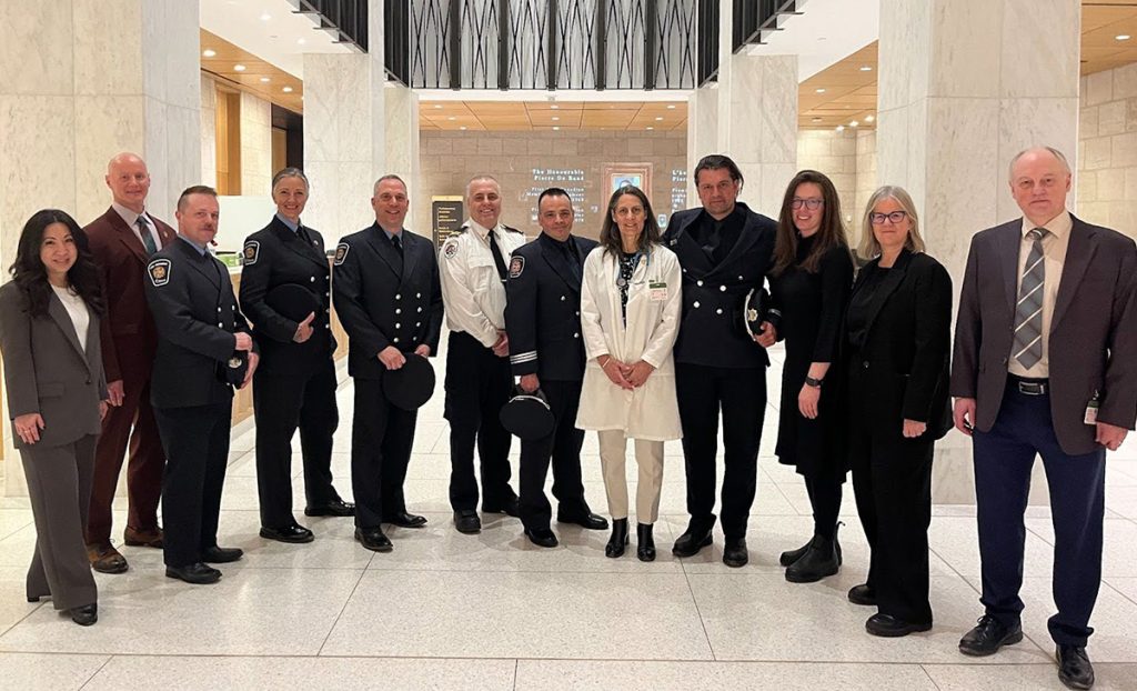 Environmentalists, firefighters, and Northern Indigenous health experts pose together in a group photo