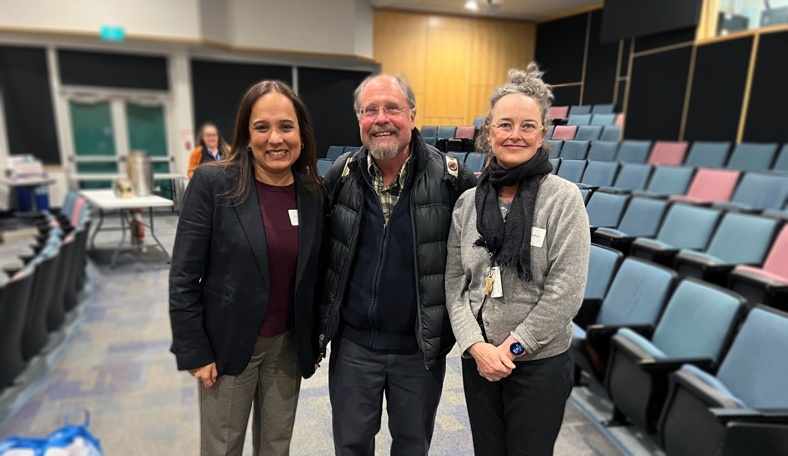 Sharon Dodd and two other CAPE physicians pose together in a theatre screening Plastic People