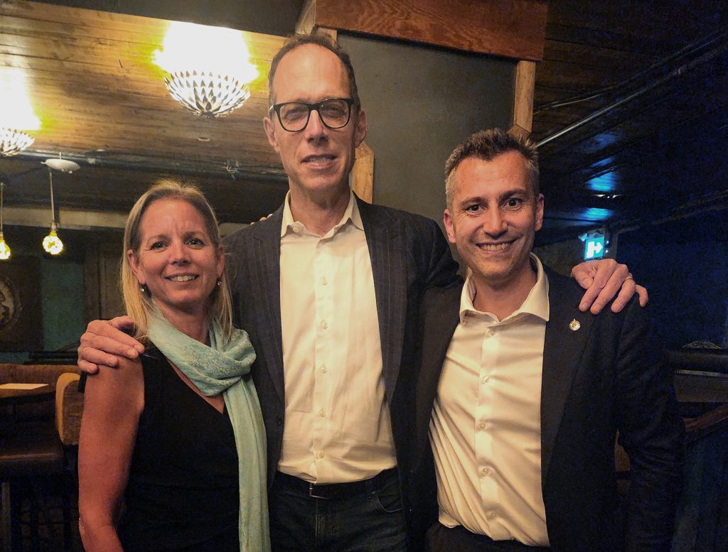 Group photo of Jane, Rick, and Eric in formal clothing smiling at the camera